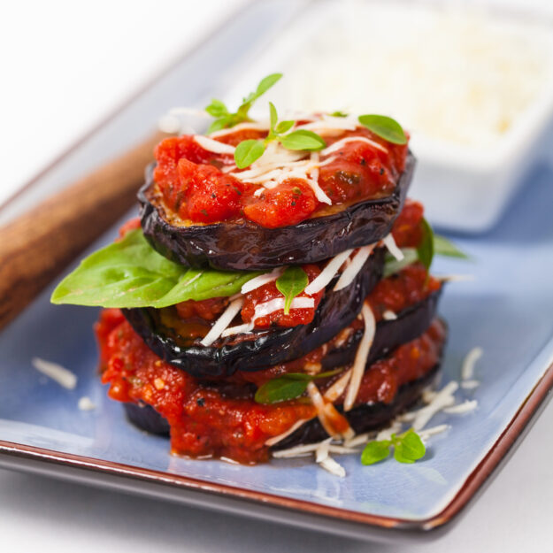 Layered Italian Eggplant Appetizer on White Background. Selectiv